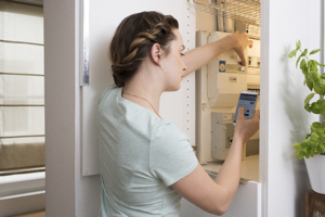 A woman reads the electricity meter or gas meter